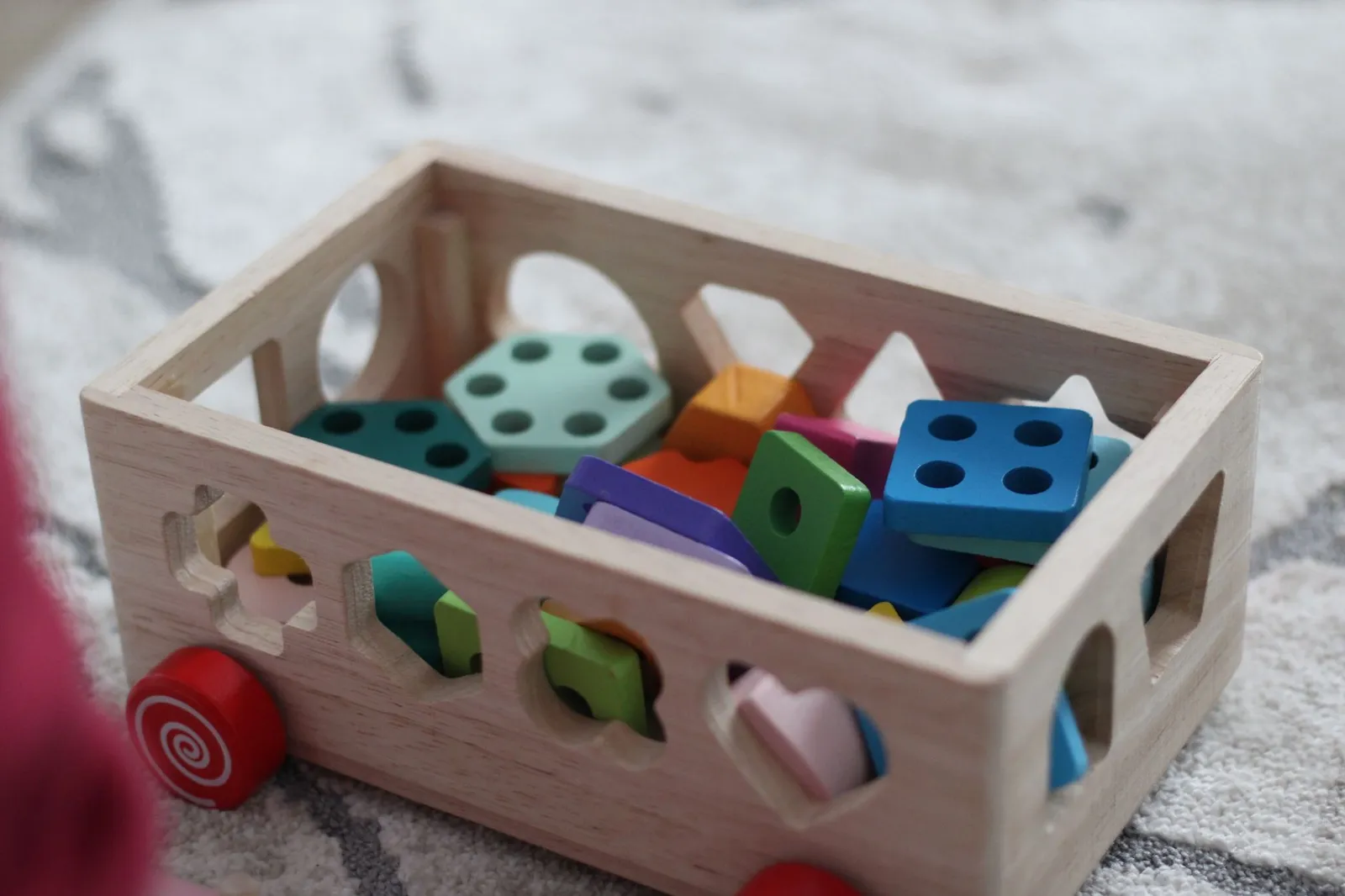 Wooden toys laid out for a children's product safety check.