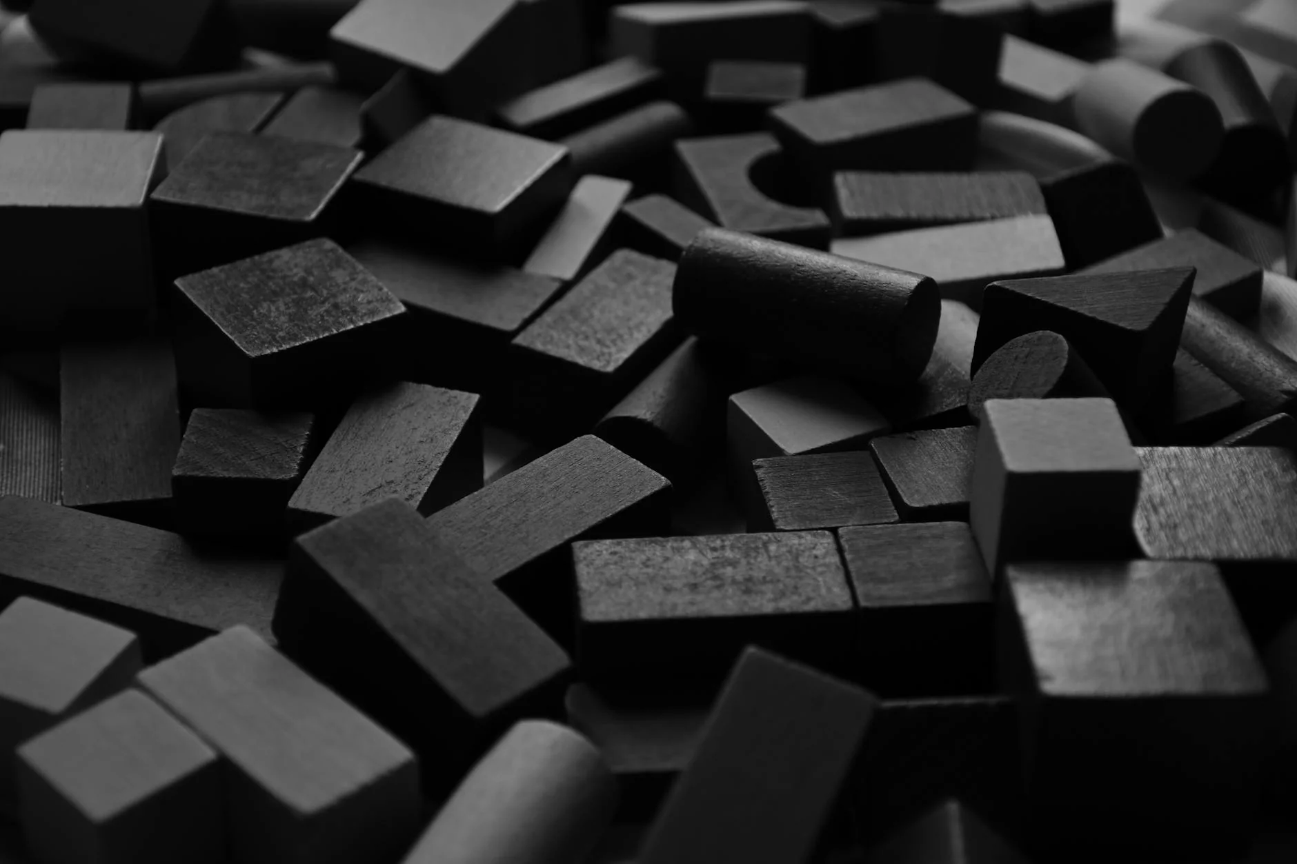 Wooden building blocks and stacking toys arranged on a light table