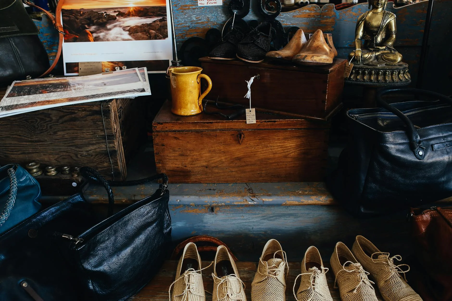 Rows of second-hand goods on wooden shelves inside a thrift store